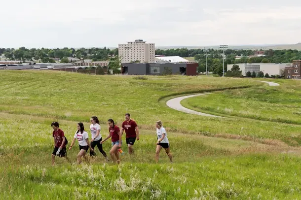 Students hike up C Hill